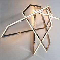 a modern wall light made out of metal strips