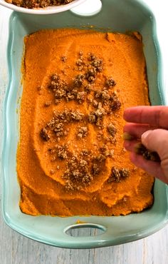 two bowls filled with sweet potato casserole on top of a wooden table