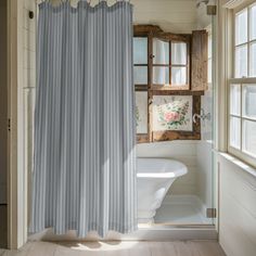 a white bath tub sitting next to a window