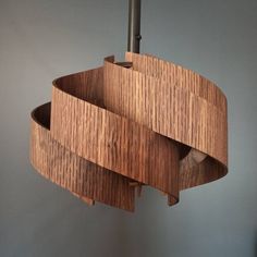 a wooden light fixture hanging from a ceiling