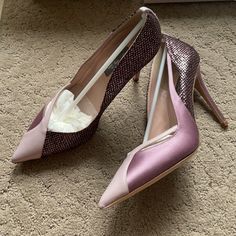 two pairs of pink and purple shoes on the floor