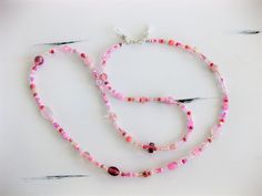 "This Pink Eyeglass Chain can also be worn as a necklace. Ralston Originals was the first to add the lobster clasp at the end of the eyeglass chain to join it together to make a Necklace. Brilliant! This makes it even more convenient because you now have two pieces of jewelry in one, and eyeglass chain for your glasses, and a beaded necklace!! The chain is made with an assortment of sizes and colors of pretty pink glass beads, and pink seed beads. The ready made chain is 26 or 32 inches long, or Pink Czech Glass Beaded Necklace For Gifts, Pink Single Strand Glass Necklace, Pink Glass Beaded Necklaces For Gift, Pink Glass Beaded Necklace For Gift, Handmade Pink Glass Beaded Necklaces, Glass Beaded Necklaces With Lobster Clasp For Gifts, Adjustable Single Strand Glass Crystal Necklace, Czech Glass Single Strand Crystal Necklace As Gift, Eyeglass Holder Necklace