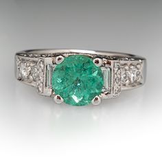 This glamorous ring is centered with one (1) round cut Seafoam tourmaline in a four-prong setting. The ring is accented with two (2) bezel set baguette cut diamonds, and forty-two (42) bead set round brilliant cut diamonds. The ring measures 7.8mm at the top, rises 8.2mm above the finger, tapering to 3.1mm wide and 1.4mm thick at the base of the shank. It is currently a size 7.25. Diamond Ring Platinum, Green Tourmaline Ring, Bead Set, Bluish Green, Baguette Cut Diamond, Tourmaline Ring, Baguette Cut, Baguette Diamond, Green Tourmaline