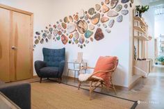 a living room filled with furniture and lots of plates on the wall above it's door