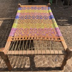 an old weaving loom is sitting on the ground