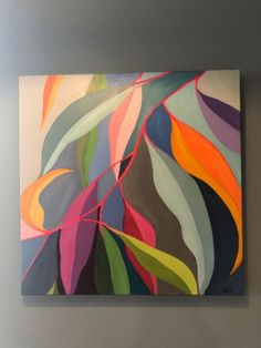 an abstract painting hangs on the wall