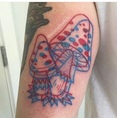 a colorful tattoo on the arm of a man with an umbrella and mushroom design in red, white and blue