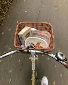 a basket on the back of a bicycle with books in it