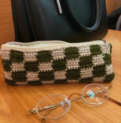 a pair of glasses sitting on top of a table next to a purse