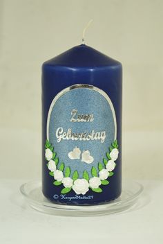 a blue candle sitting on top of a glass plate