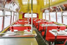 the interior of a train car with tables and chairs set up for diners to eat