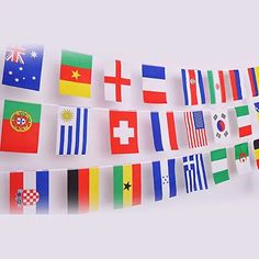 a bunch of flags are hanging on a white wall and there is no image here to provide a caption for