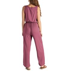 Made from super soft, lightweight stretchy fabric, this jumpsuit is designed to be worn for any season or occasion, making it a staple in your wardrobe. The flattering relaxed fit and wide-leg style with side pockets add a touch of casual sophistication, while the open V-neck and elastic waistband with a drawstring tie create a flattering silhouette that complements any body type. Dress it down with your favorite sandals for a laid-back daytime look or dress it up with wedges and sparkling state Comfortable Relaxed Fit Overalls, Solid Maxi Length Jumpsuits And Rompers For Loungewear, Maxi Length Jumpsuits And Rompers For Loungewear, Comfortable Overall Jumpsuits And Rompers For Loungewear, Relaxed Fit Jumpsuits And Rompers For Loungewear, Solid Color Relaxed Fit Jumpsuits For Loungewear, Comfortable Jumpsuits And Rompers For Loungewear, Wide Leg Jumpsuit For Beach, Lounging Jumpsuits And Rompers