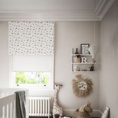 a baby's room with white walls and wooden floors