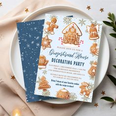 two gingerbread house christmas party cards on a white plate with gold stars and greenery