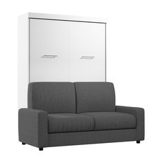 a gray couch sitting next to a white cabinet