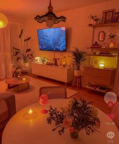 a living room filled with furniture and a flat screen tv mounted to the side of a wall