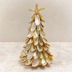 a small christmas tree made out of shells