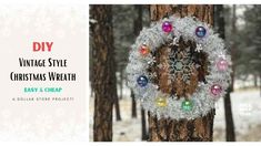 a christmas wreath hanging from the side of a tree in front of snowflakes