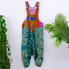 Kantha Harem Jumpsuit, Handmade Boho Dungarees, Bohemian Cotton Overalls, Handstitched One of a Kind Recycled Jumpsuit with Pockets, Vintage Handmade in India Material: Cotton Kantha is a type of embroidery originating from the Indian subcontinent, specifically from the regions of Bangladesh and West Bengal in India. It is characterized by running stitches that are often used to repurpose old saris and fabrics into new unique and colorful pieces. This Kantha Harem  Boho Jumpsuit is a one-of-a-kind piece, handmade with vintage cotton fabric and hand-stitched using traditional kantha techniques. Its wide leg and bohemian style offer a unique and comfortable fit, while the two side pockets add practicality. Embrace sustainable and fashion-forward style with this upcycled jumpsuit. Size: One S Green Bohemian Cotton Jumpsuits And Rompers, Bohemian Cotton Jumpsuits And Rompers With Patchwork, Green Cotton Jumpsuit With Patchwork, Bohemian Green Jumpsuits And Rompers For Festival, Fitted Bohemian Jumpsuits And Rompers, Bohemian Fitted Jumpsuits For Festivals, Boho Dungarees, Indian Subcontinent, Cotton Overalls