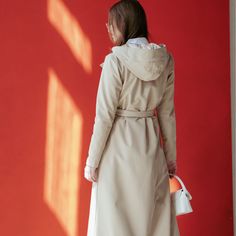 This classic beige coat, embodies the elegance of traditional trench style with a modern trapeze cut. Lined with luxurious light beige Italian satin, it combines classic sophistication with practicality, featuring an adjustable hood, hidden side-seam pockets, and a belt featuring silver-tone hardware. The water-resistant fabric (10’000 mm - not appropriate for heavy showers) offers warmth and breathability, making it a perfect blend of iconic style and comfort. Membrane fabric: breathable (5 000 Classic Long Beige Raincoat, Beige Notch Lapel Gabardine Outerwear, Beige Cotton Outerwear With Double-lined Hood, Beige Single-breasted Outerwear With Notch Lapel, Beige Double-breasted Gabardine Outerwear, Beige Coat, Iconic Style, Water Resistant Fabric, Jewelry Ring Box