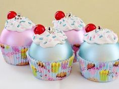 three cupcakes with frosting and sprinkles on them are sitting next to each other