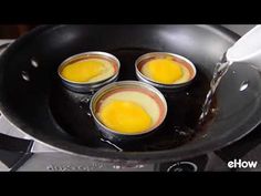 four eggs being cooked in a pan on the stove