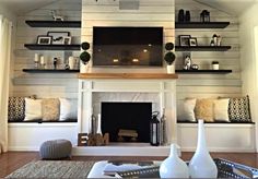 a living room filled with furniture and a flat screen tv mounted on the wall above a fire place