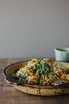 a bowl filled with food sitting on top of a wooden table