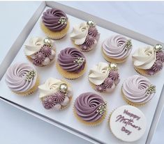 twelve cupcakes with pink frosting and gold decorations