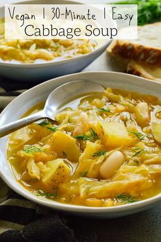 two bowls of soup with bread on the side