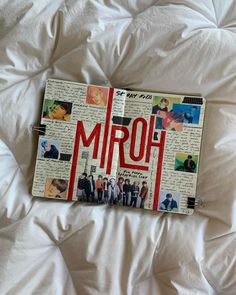 an open notebook with the word mrq on it laying on a white bed sheet