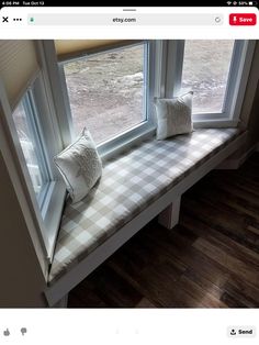 a window seat with two pillows on it