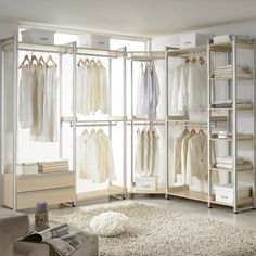 an open closet with clothes hanging on the walls and carpeted flooring in front of it