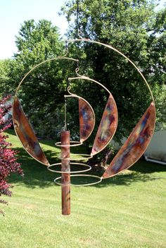 a metal sculpture in the middle of a yard