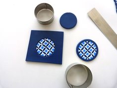 some blue and white items on a table with scissors, spoons and other things