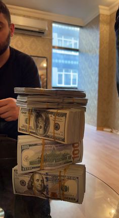 a stack of money sitting on top of a glass table