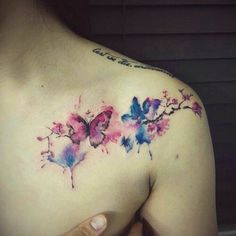 a woman's chest with watercolor butterflies on it