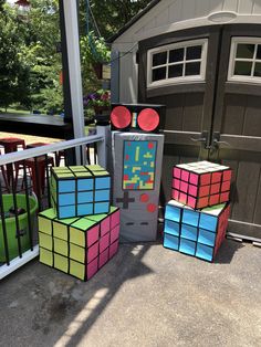 several rubik cubes are stacked on top of each other in front of a garage