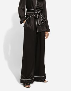 Stretch silk satin pajama pants with contrasting piping: Black Stretch Dolce high waist Front slant pockets Faux fly on the center front Inner leg: 77 cm Hem: 30.4 cm The model is 175 cm tall and wears a size IT 40 Made in Italy Elegant Black Pants Set, Elegant Black Long Pants Set, Black Satin Loungewear Bottoms, Elegant Black Pajama Party Set, Black Satin Wide-leg Pants, Elegant Black Wide Leg Pants For Loungewear, Chic Black Wide Leg Pants For Daywear, Elegant Wide Leg Bottoms For Pajama Party, Wide Leg Black Pants For Pajama Party