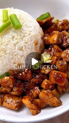 chicken and rice on a white plate with green onions