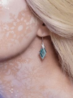 the back of a woman's head wearing earrings