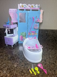 there is a toy bathroom with toys in it