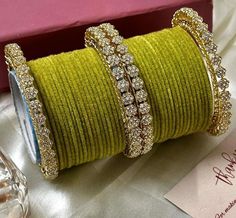 Add a touch of elegance to your wrist with this stunning Fancy Star Bangles Bangles Set. Inspired by the beautiful jewelry of India, this brass bangle set features a unique design with a gold main stone colour that will make you stand out in any crowd. Perfect for women who love to accessorise, this bangle set is a must-have addition to your collection. Crafted with care and attention to detail, this bangle set is perfect for any occasion. The intricate design and the high-quality materials make Gold Fusion Bangle For Diwali, Gold Fusion Style Bangle For Diwali, Gold Fusion Bangle For Celebration, Gold Fusion Bangle For Weddings, Gold Tilla Bangle For Party, Festive Yellow Bangle Jewelry, Gold Bollywood Bangle For Parties, Gold Bollywood Bangle As A Gift, Yellow Gold Bangle With Stone Work For Gifts