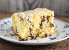 a piece of cake sitting on top of a white and blue plate next to a fork