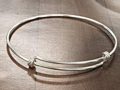 New for 2015. Now Available in Solid 925 Sterling Silver with Anti Tarnish Coating. The bracelet adjusts from 8 Inch to 9.50 Inch. The wire is 16 Gauge or 1.65mm. Make Personalized Bracelets and tell your story. Make special occasions memorable by having a keepsake piece of jewelry. Make your own celebrity style charm bracelet. Since it is sterling silver you do not have to worry about plating wearing off.. Buy one or stack up multiples, choice is yours. Need larger Quantities, please CONVO with Classic Adjustable Nickel-free Charm Bracelet, Adjustable Round Sterling Silver Bracelet For Gifts, Adjustable Round Sterling Silver Bracelet As Gift, Adjustable Sterling Silver Round Bracelet As A Gift, Adjustable Sterling Silver Bracelet As A Gift, Adjustable Sterling Silver Bangle For Everyday, Adjustable Everyday Sterling Silver Bangle Bracelet, Classic Adjustable Charm Bracelet, Adjustable Hypoallergenic Silver Bracelet