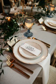 the table is set with place cards and silverware