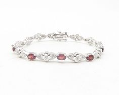 925 Sterling Silver - Red Topaz & Genuine Diamonds Floral Chain Bracelet- BT4741  925 Sterling Silver - Red Topaz & Genuine Diamonds Floral Chain Bracelet- BT4741  Jewelry Type:         Bracelet   Metal Type:            925 Silver  Metal Size:             7.25" Length   Stone Type:            Diamond & Topaz   Condition:              N/A  Jewelry Weight:     15.8 Grams  PLEASE NOTE: THIS ITEM IS PRE-OWNED. ALTHOUGH MOST ITEMS ARE IN VERY GOOD CONDITION, SOME MAY NEED CLEANING AND/OR MINOR REPAIRS. WE MAKE A VERY STRONG EFFORT TO UPLOAD CLEAR PICTURES. PLEASE INSPECT ALL PICTURES AND ASK ALL QUESTIONS YOU MAY HAVE PRIOR TO MAKING A PURCHASE. NOT ALL STONES ARE GENUINE, SOME ARE ENHANCED OR CREATED. Red Garnet Jewelry With Diamond Accents, Red Diamond Accents Bracelet, Red Diamond Accented Bracelet, Luxury Silver Garnet Jewelry, Red Diamond Accents Bracelets For Anniversary, Red Bracelets With Diamond Accents For Anniversary, Red Diamond Accents Bracelet For Anniversary, Red Diamond Accent Bracelets For Anniversary, Red Sterling Silver Anniversary Bracelet