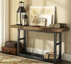 a wooden table topped with books and candles