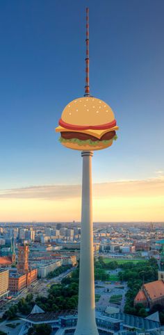 an aerial view of a large city with tall buildings and a tower that has a hamburger on it